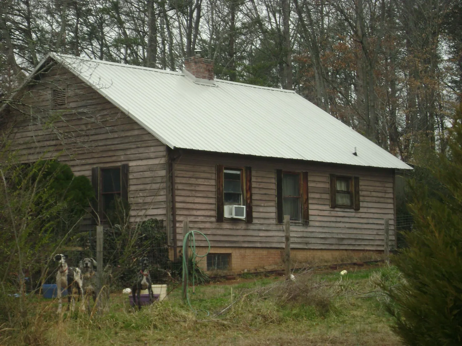 White metal roof on an old wood sided farmhouse in Titusville